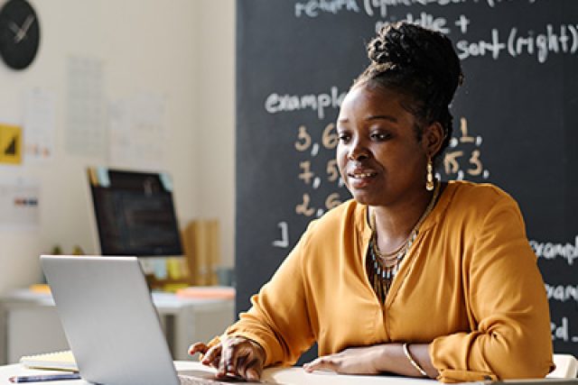 black female teacher at laptop